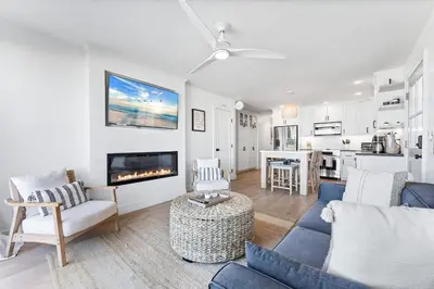 a living room with a blue couch and a fireplace at Entire Ground Beachfront Luxury Unit with Patio in San Diego