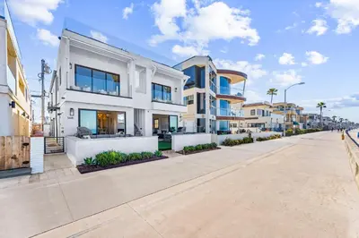 a large white building on the side of a street at Entire Ground Beachfront Luxury Unit with Patio in San Diego