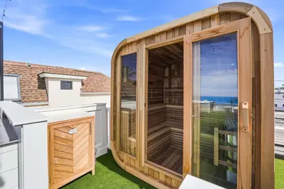 a wooden garden room with a large window on a balcony at Luxury oceanfront fourplex with roof deck sleeps 22 in San Diego
