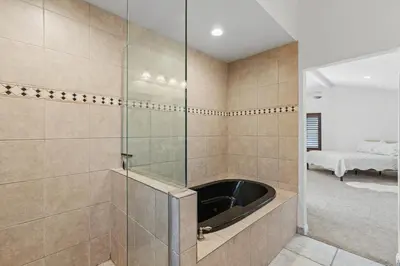 a bathroom with a glass shower with a tub at Peaceful Getaway with Renovated Amenities in San Diego