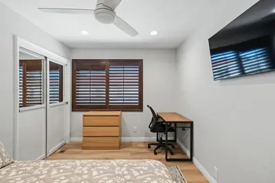 a bedroom with a bed and a desk and a tv at Peaceful Getaway with Renovated Amenities in San Diego
