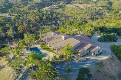 an aerial view of a house with palm trees at Gorgeous Private Estate with Pool & Pickleball Court in Lakeside