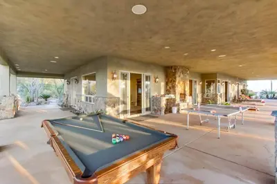 a pool table in a room with two tables at Gorgeous Private Estate with Pool & Pickleball Court in Lakeside