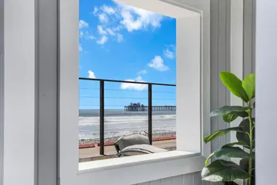 a window with a view of the beach at The Shining Sea A in Oceanside