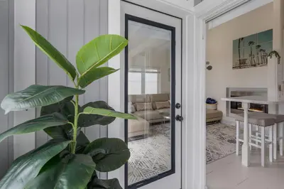 a plant in front of a mirror in a room at The Shining Sea A in Oceanside