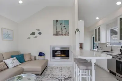 a kitchen and living room with a couch and a fireplace at The Shining Sea A in Oceanside