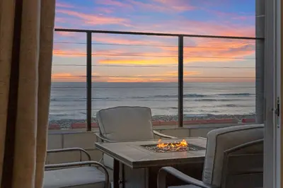 a room with a table and chairs and a view of the ocean at The Shining Sea A in Oceanside