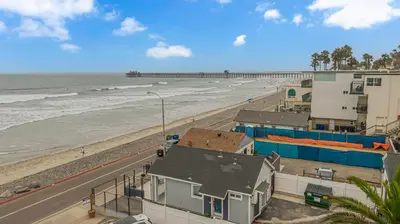 a view of a beach with buildings and the ocean at The Shining Sea A in Oceanside