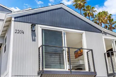 a house with a window with an umbrella in it at The Shining Sea B in Oceanside