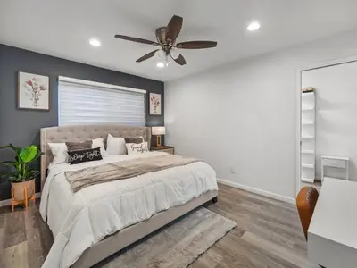 a bedroom with a bed and a ceiling fan at Super Spacious Family Vacation House! in San Diego
