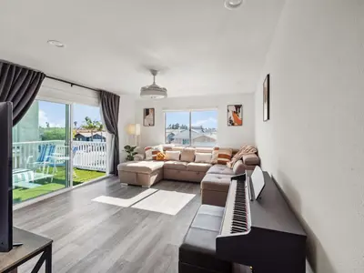 a living room with a couch and a table at Super Spacious Family Vacation House! in San Diego