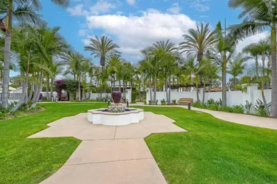 a fountain in a park with palm trees at Heated Pool & Hot Tub Access, Walk 2 Omni Resort, Free Parking, Wi-Fi, Washer & Dryer in Encinitas