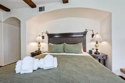 a bedroom with a large bed with two lamps at Heated Pool & Hot Tub Access, Walk 2 Omni Resort, Free Parking, Wi-Fi, Washer & Dryer in Encinitas