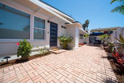 a house with a brick patio in front of it at La Jolla Windansea Luxury Apt in San Diego