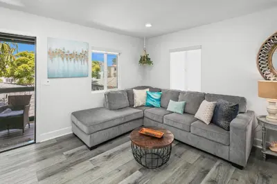 a living room with a couch and a table at Modern 1 BR Apt - Walk to Ocean & Cafes in San Diego