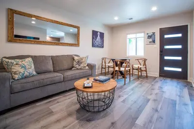 a living room with a couch and a table at 5BD Family, Event Friendly 4plex Steps2Beach in San Diego