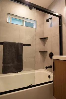 a bathroom with a glass shower with a towel at 5BD Family, Event Friendly 4plex Steps2Beach in San Diego