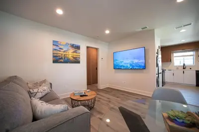 a living room with a couch and a table at 5BD Family, Event Friendly 4plex Steps2Beach in San Diego