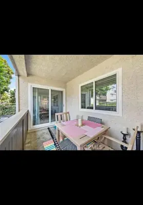 a dining room with a table and chairs on a balcony at Golden Gateaway in Dana Point