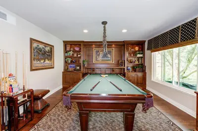 a pool table in a room with wooden walls at The Sanctuary in Laguna Hills