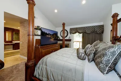 a bedroom with a bed and a flat screen tv at The Sanctuary in Laguna Hills