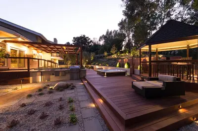 a house with a wooden deck with furniture and lights at The Sanctuary in Laguna Hills