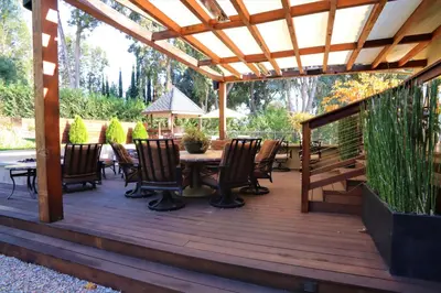 a wooden deck with a table and chairs at The Sanctuary in Laguna Hills