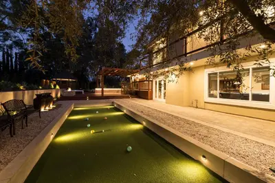 a pool in the backyard of a house at night at The Sanctuary in Laguna Hills