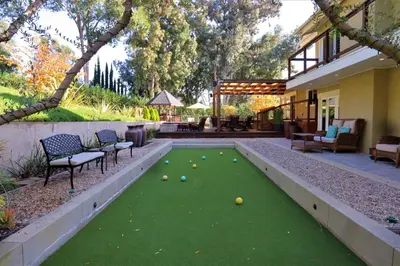a backyard with a lawn shuffleboard in the yard at The Sanctuary in Laguna Hills