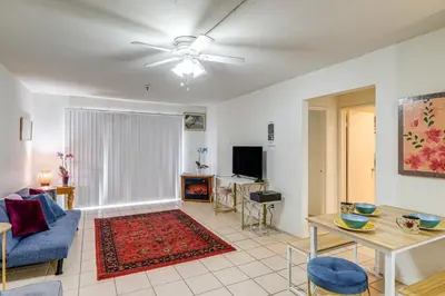 a living room with a blue couch and a table at Condo Near Hospitals and half Mi to Mission Bay! in San Diego