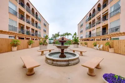 a courtyard with a fountain and benches and buildings at Condo Near Hospitals and half Mi to Mission Bay! in San Diego