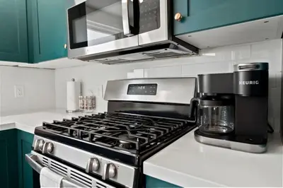 a kitchen with a stove and a coffeemaker at North Park Boho Bungalow by Rather Be Properties in San Diego