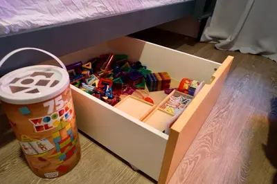 a box filled with toys and a cup next to a table at Private Family Friendly Guest Home in San Diego