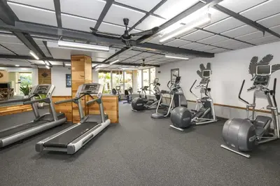 a gym with several treadmills and elliptical machines at C302 - Surfside Sactuary in Oceanside
