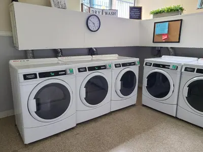 two washing machines sitting next to each other in a laundry room at C302 - Surfside Sactuary in Oceanside
