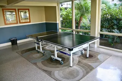 a ping pong table in a room with windows at C302 - Surfside Sactuary in Oceanside