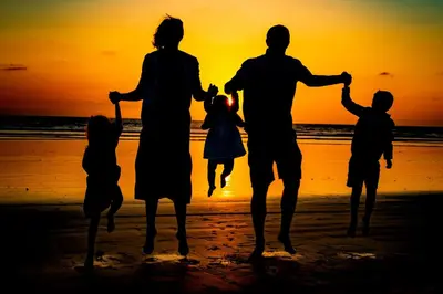 a family walking on the beach at sunset at C302 - Surfside Sactuary in Oceanside