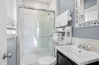 a bathroom with a shower and a toilet and a sink at 1628 West Oceanfront Oasis - All Units in Newport Beach