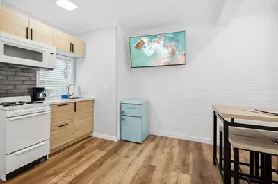 a kitchen with a blue refrigerator next to a table at 1628 West Oceanfront Oasis - All Units in Newport Beach