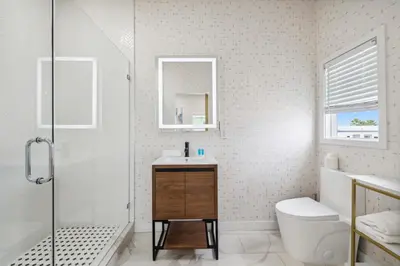 a bathroom with a shower and a sink and a toilet at 1628 West Oceanfront Oasis - All Units in Newport Beach