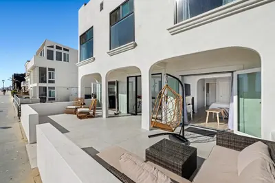 a large white house with a patio with furniture at 1628 West Oceanfront Oasis 2 in Newport Beach