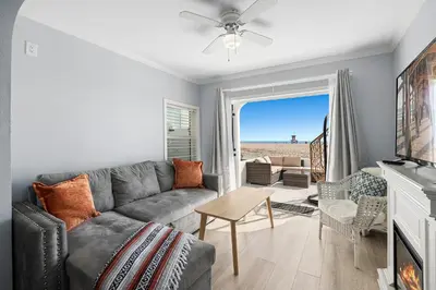 a living room with a couch and a table at 1628 West Oceanfront Oasis 2,3 in Newport Beach