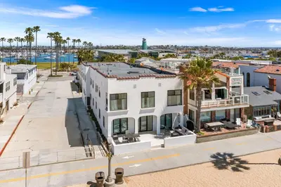an aerial view of a white building with palm trees at 1628 West Oceanfront Oasis 3 in Newport Beach