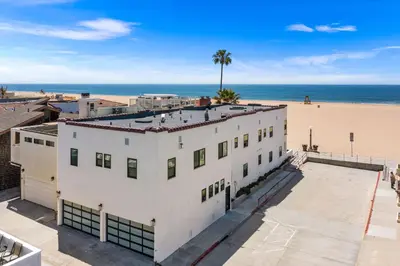 an aerial view of a white building next to the beach at 1628 West Oceanfront Oasis 3 in Newport Beach