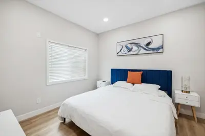 a bedroom with a large white bed and a window at West Oceanfront Oasis 4 in Newport Beach