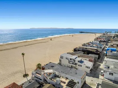 an aerial view of a beach with buildings and the ocean at West Oceanfront Oasis 4 in Newport Beach