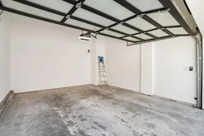an empty garage with a ladder in it at 1628 West Oceanfront Oasis 8 in Newport Beach