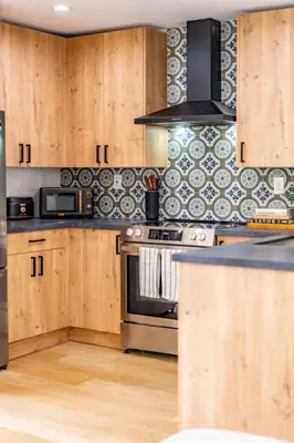 a kitchen with wooden cabinets and a stove top oven at Quaint Studio in Charming Marston Hills in San Diego