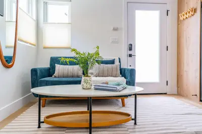 a living room with a blue couch and a coffee table at Quaint Studio in Charming Marston Hills in San Diego