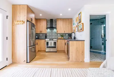 a kitchen with wooden cabinets and a stainless steel refrigerator at Quaint Studio in Charming Marston Hills in San Diego